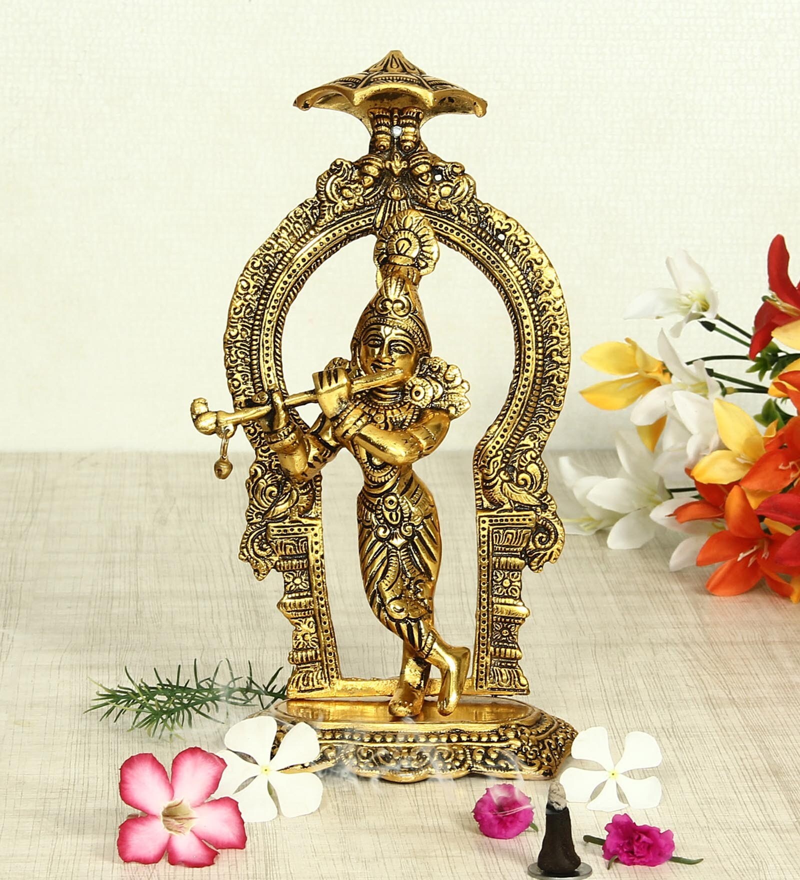 Antique Golden Aluminium Lord Krishna Playing Flute With A Frame At The Back Carved In Antique Golden Finish Idol