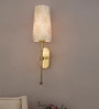 Antique Brass Long Arm Wall Sconce with Palm Motif Shade