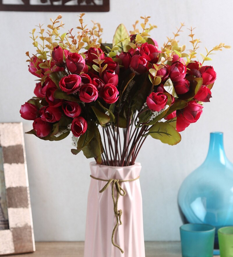 red artificial flowers in vase