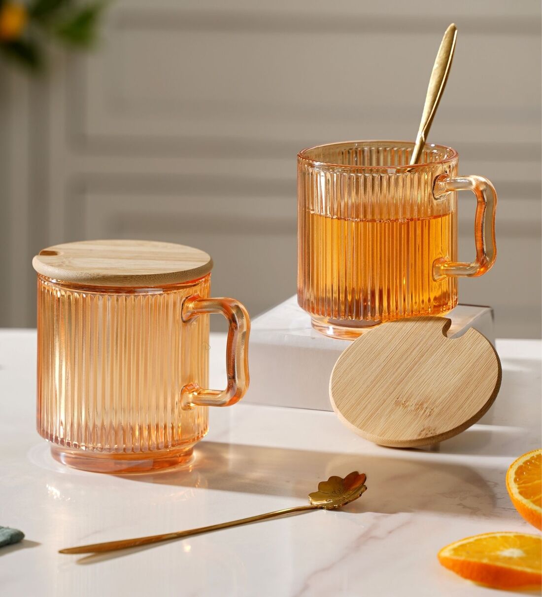 https://ii1.pepperfry.com/media/catalog/product/a/u/1100x1210/aurora-ribbed-350ml-amber-glass--set-of-2--coffee-mug-with-wooden-lid---metal-spoon-aurora-ribbed-35-lqro5r.jpg