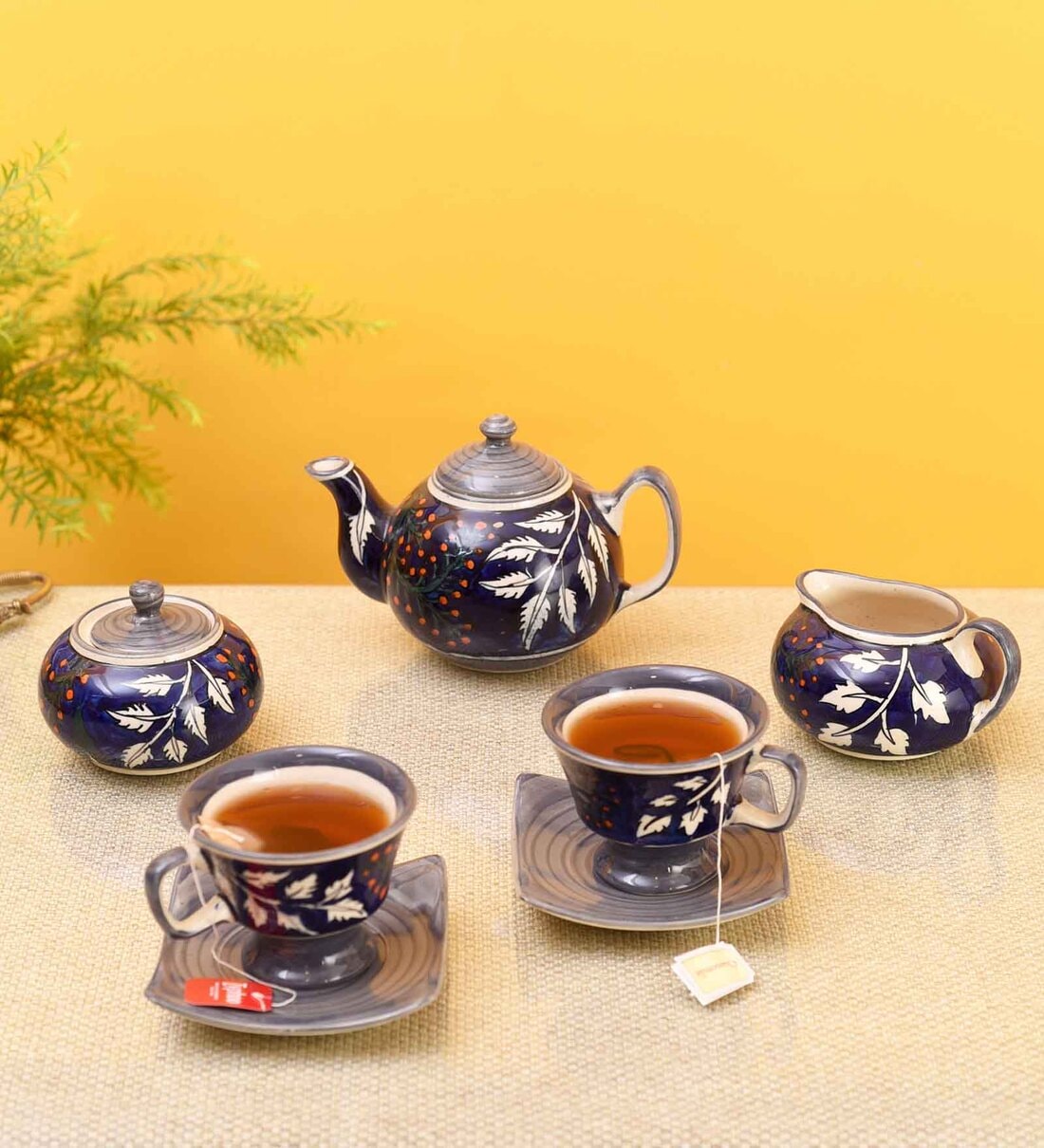 https://ii1.pepperfry.com/media/catalog/product/b/l/1100x1210/blooming-leaves-tea-set-w-cups--saucer---creamer-blooming-leaves-tea-set-w-cups--saucer---creamer-wnmz5b.jpg