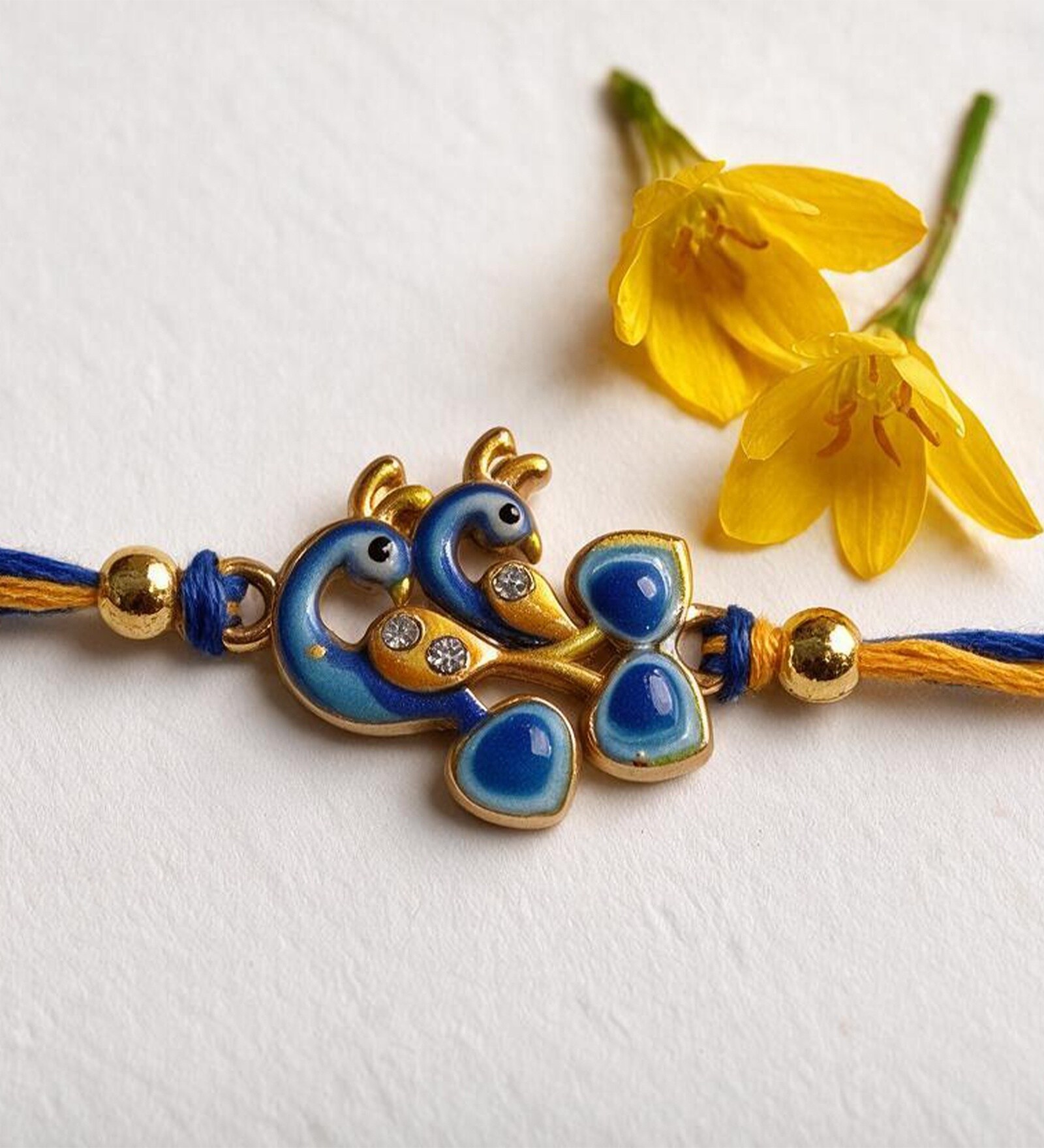 Blue & Gold Handmade Twin Peacock Rakhi With Blue Enamel, Crystal Stones, Gold Beads & Premium Cotton Thread