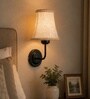 Black Wall Mounted Lamp with Beige Jute Shade & Dining Area