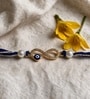 Blue Handmade Infinity Evil Eye Rakhi With Crystal Stones, Pearl Beads & Cotton Thread