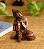Brown Metal Resting Buddha On Knee