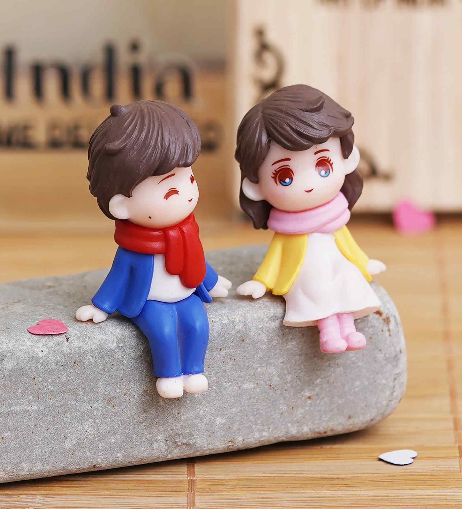 Cute Boy & Girl Sitting Multicolour Polyresin Showpieces