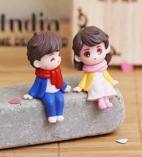 Cute Boy & Girl Sitting Multicolour Polyresin Showpieces