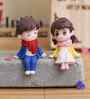 Cute Boy & Girl Sitting Multicolour Polyresin Showpieces