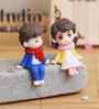 Cute Boy & Girl Sitting Multicolour Polyresin Showpieces