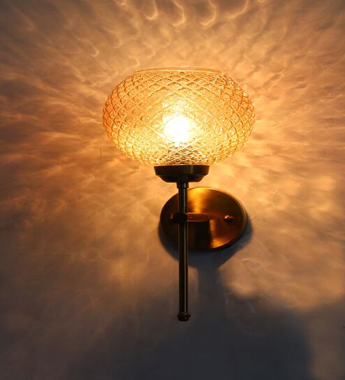 Elegant Brass Wall Sconce with Amber Crystal Globe Glass