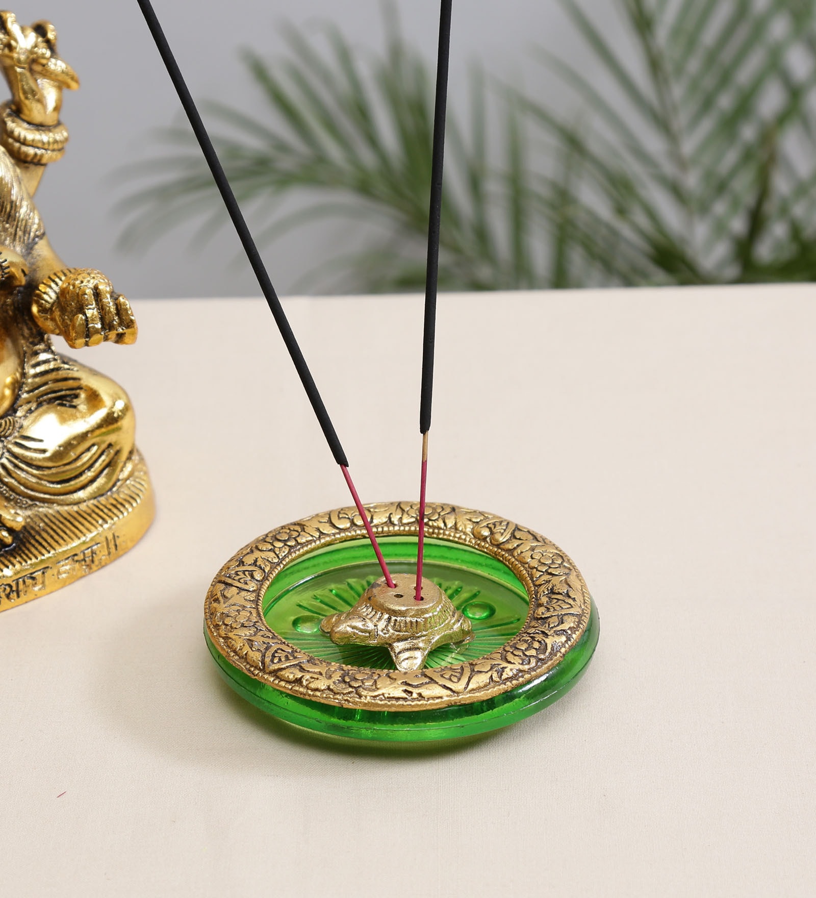 Gold Metal Tortoise Incense Holder Placed In Green Glass
