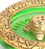Gold Metal Tortoise Incense Holder Placed In Green Glass