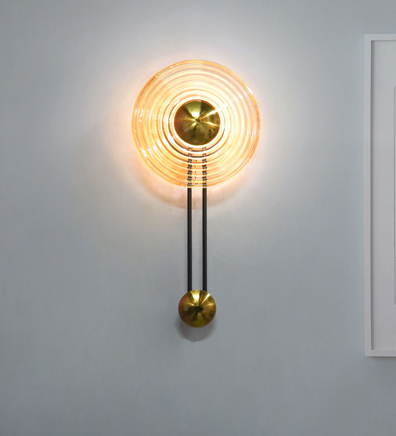 Modern Golden Pendulum-Style Steel And Round Amber Glass Decorative LED Wall Lamp