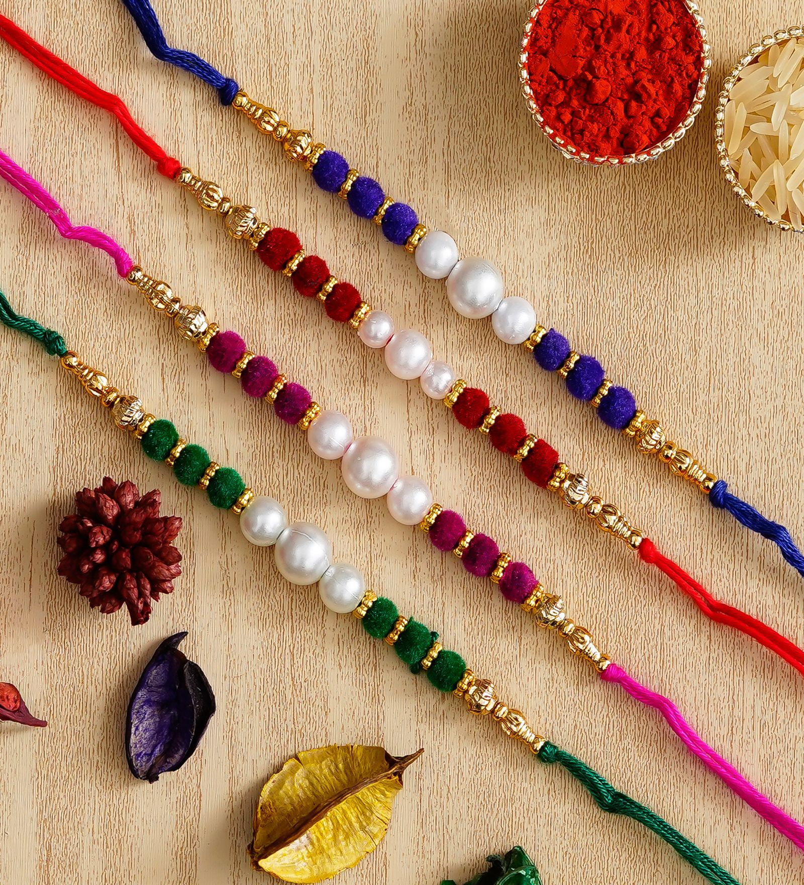 Buy Multicolor Set of 4 Designer Pearl Rakhis with Roli Chawal Pack at ...