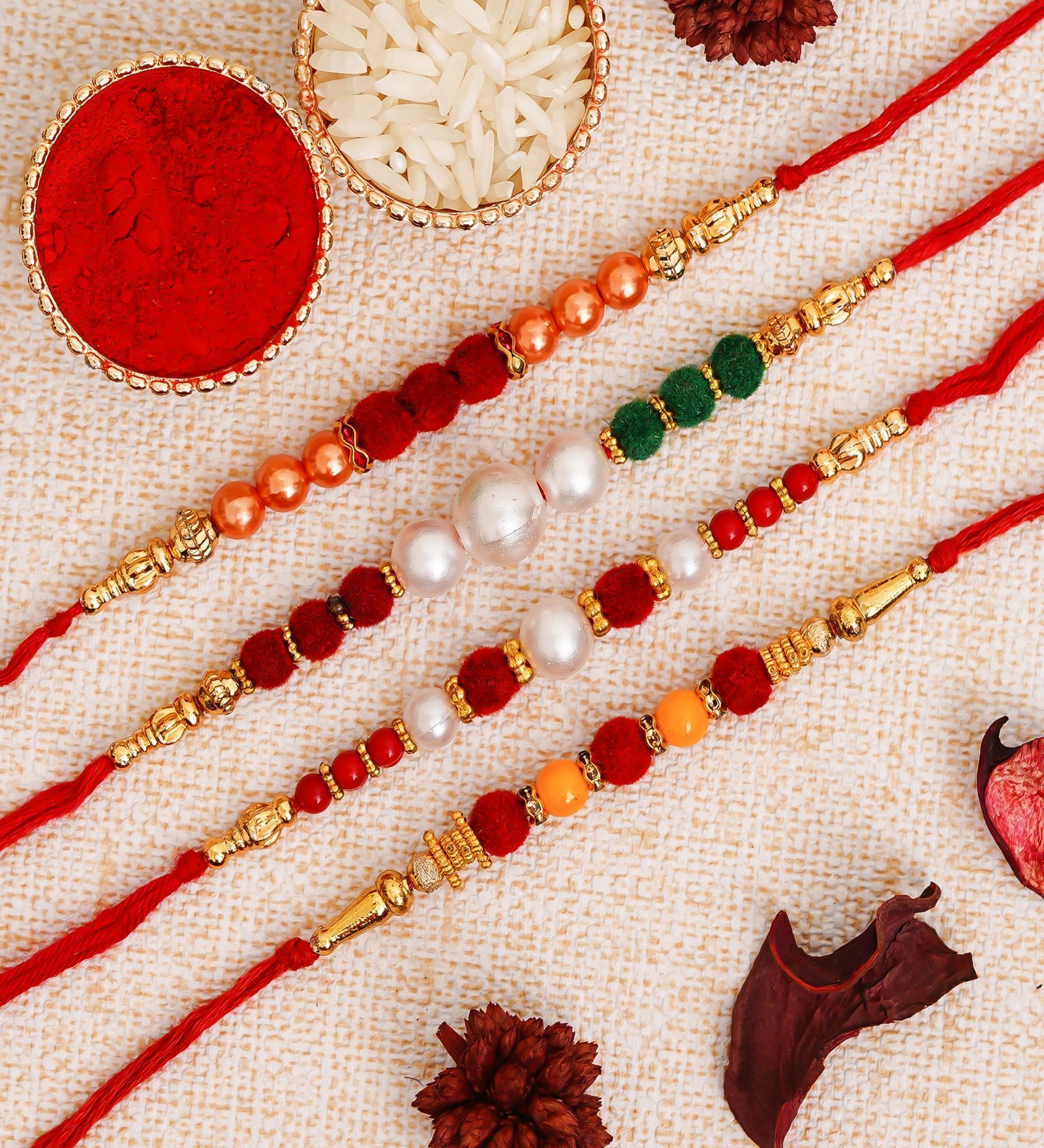 Buy Multicolor Set of 4 Designer Pearl Rakhis with Roli Chawal Pack at ...