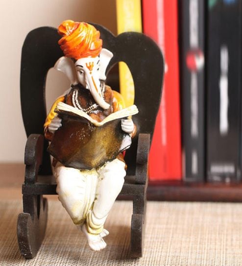 Buy Orange Polyresin Lord Ganesha Reading Book On Wooden Chair