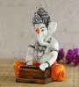 Orange Lord Ganesha Playing Harmonium Decorative Showpiece