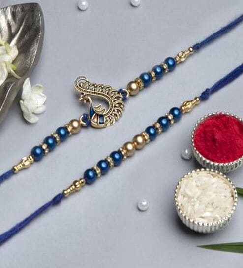 Set of 2 Blue & Golden Pearls and Peacock Designer Rakhis with Roli Chawal Pack