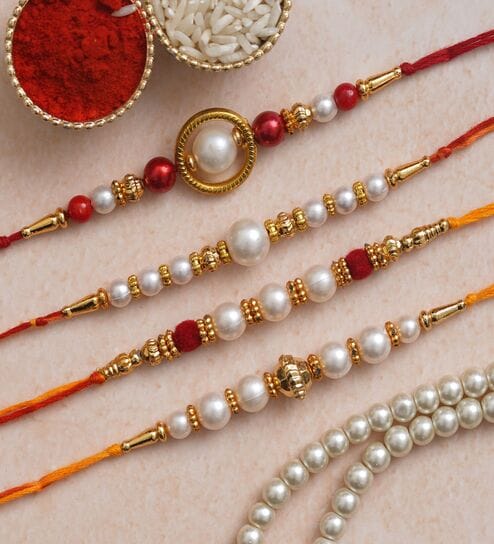 Set of 4 Red, Golden White Pearls Rakhis with Roli Chawal Pack